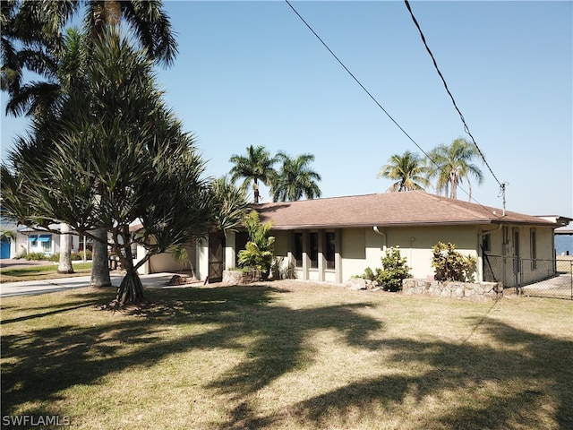 rear view of house featuring a yard