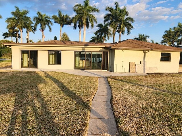 view of front of property with a patio area and a front lawn