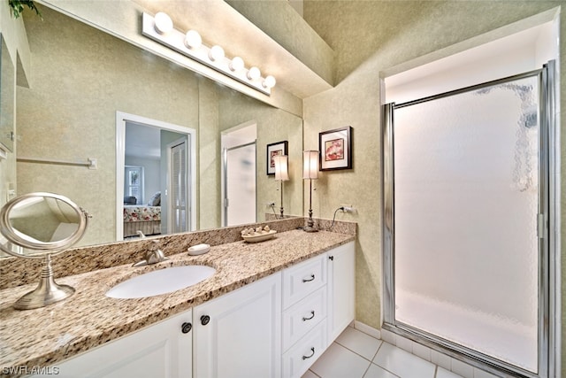 bathroom featuring walk in shower, tile floors, and vanity