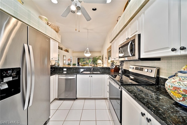 kitchen featuring ceiling fan, appliances with stainless steel finishes, sink, light tile floors, and white cabinets