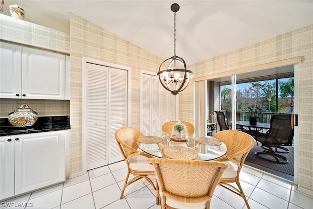 tiled dining space with an inviting chandelier and vaulted ceiling