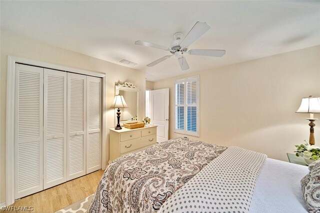 bedroom featuring a closet, ceiling fan, and light wood-type flooring