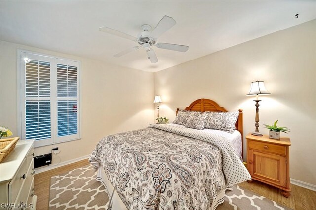 bedroom with ceiling fan and light wood-type flooring