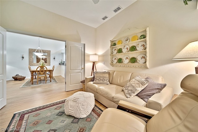 living room featuring light hardwood / wood-style flooring and lofted ceiling