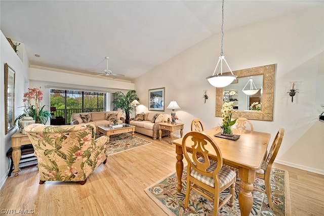 dining area featuring high vaulted ceiling, ceiling fan, and light hardwood / wood-style flooring