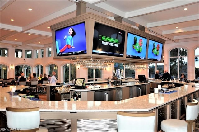 bar with fridge, light stone countertops, and beamed ceiling