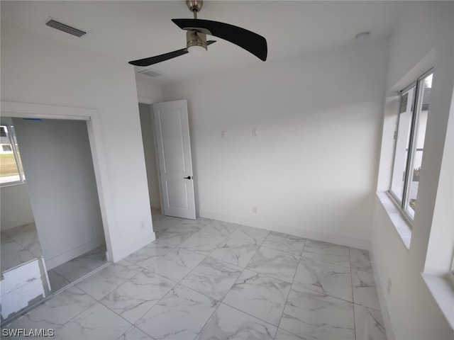 unfurnished bedroom featuring ceiling fan and light tile flooring