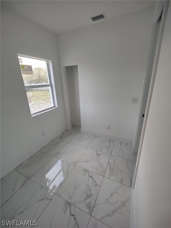 unfurnished room with light tile floors