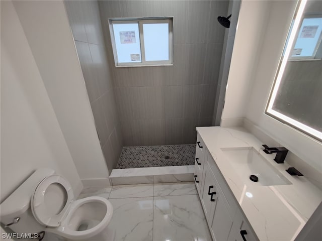 bathroom with a wealth of natural light, tiled shower, toilet, and tile flooring