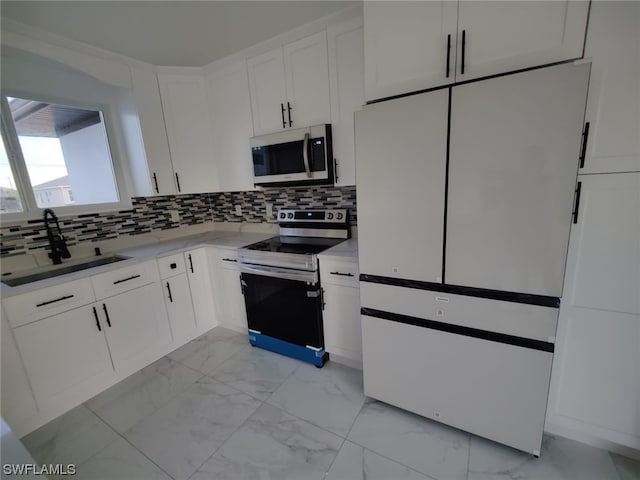 kitchen featuring electric stove, white cabinets, sink, tasteful backsplash, and high end white fridge