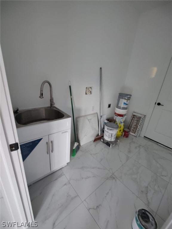 laundry room with sink and light tile floors