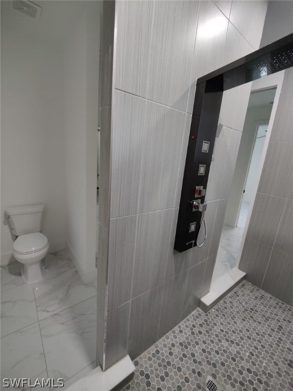 bathroom with tile floors and toilet