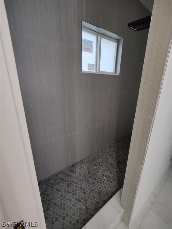 bathroom with tiled shower