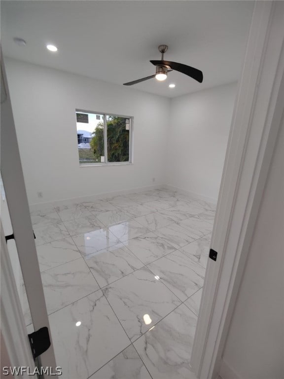 unfurnished room featuring ceiling fan and light tile floors