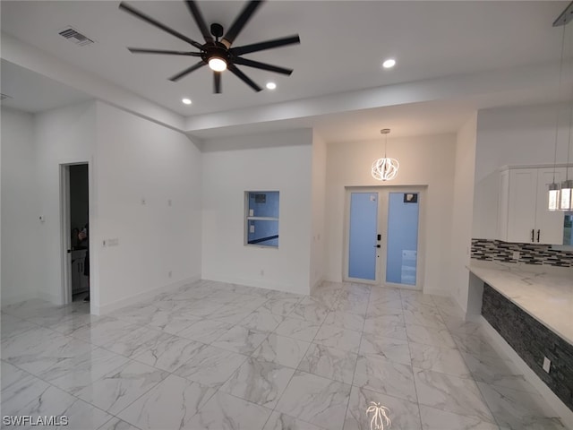 unfurnished living room featuring french doors, ceiling fan, and light tile floors