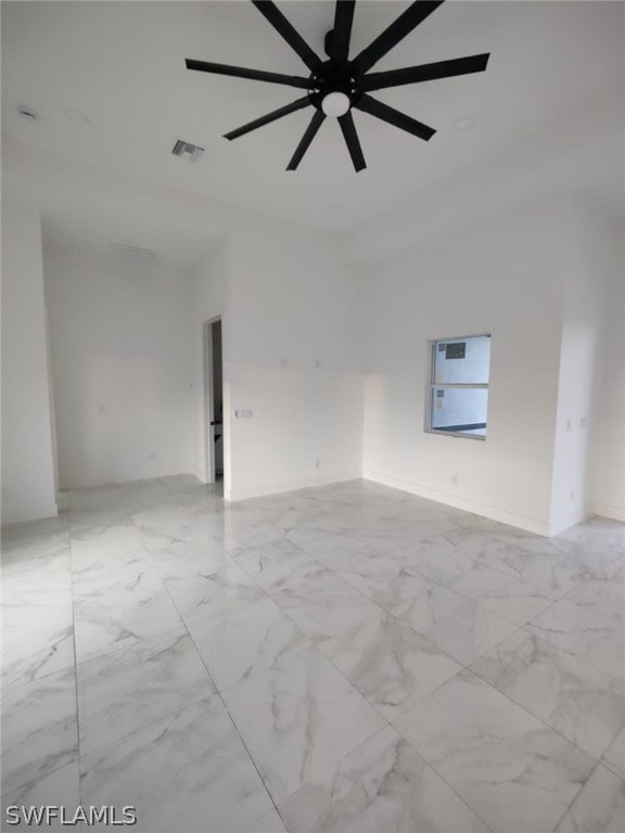 unfurnished room featuring ceiling fan and light tile floors