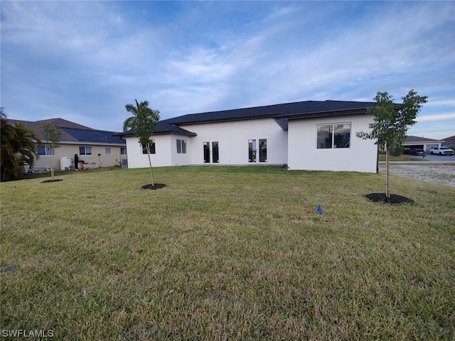 rear view of property with a yard