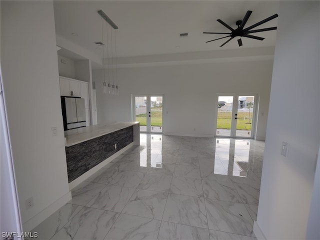 kitchen featuring plenty of natural light, french doors, pendant lighting, and light tile flooring