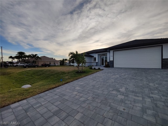 ranch-style home featuring a garage and a front yard