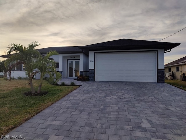 view of front of property featuring a garage and a yard