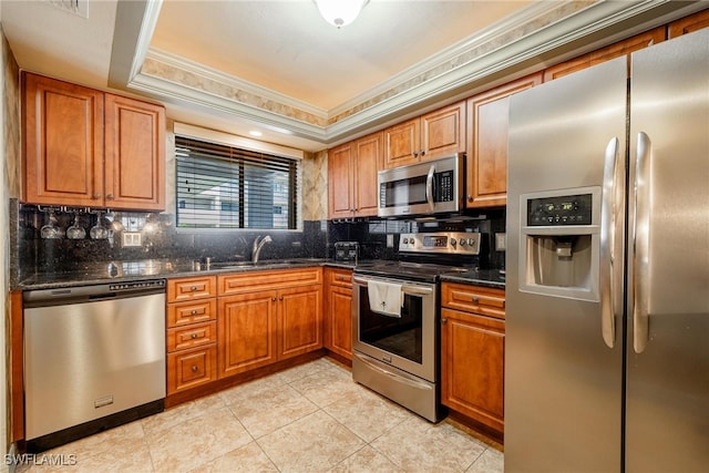 kitchen with appliances with stainless steel finishes, backsplash, light tile patterned flooring, ornamental molding, and dark stone counters