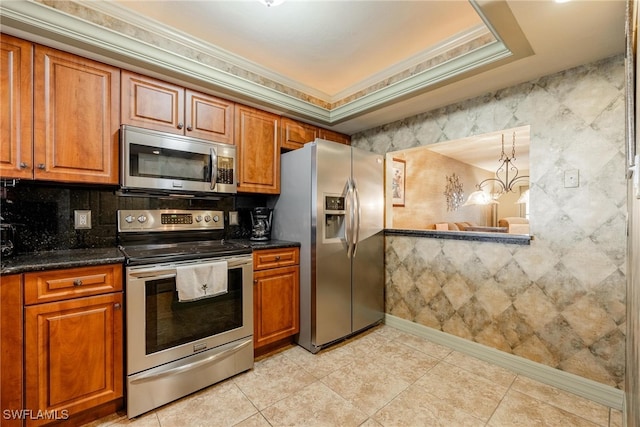 kitchen with light tile patterned flooring, stainless steel appliances, and crown molding