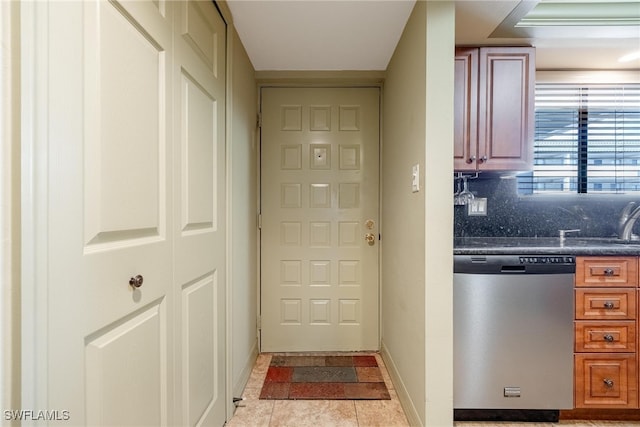 doorway to outside with light tile patterned flooring