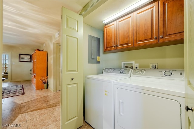 laundry room with electric panel, independent washer and dryer, light tile patterned floors, and cabinets