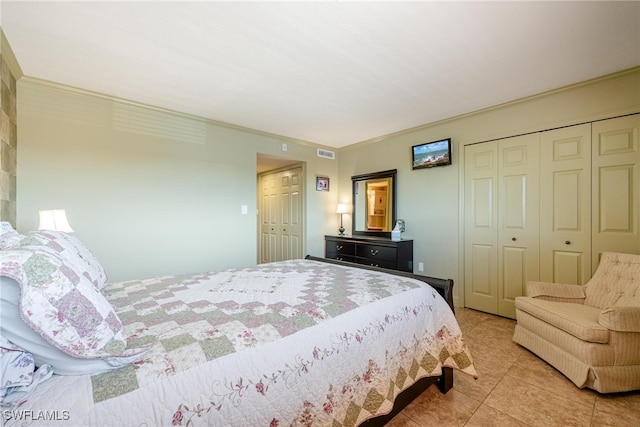 bedroom featuring ornamental molding and tile patterned floors