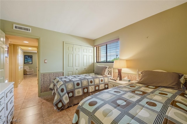 tiled bedroom with a closet