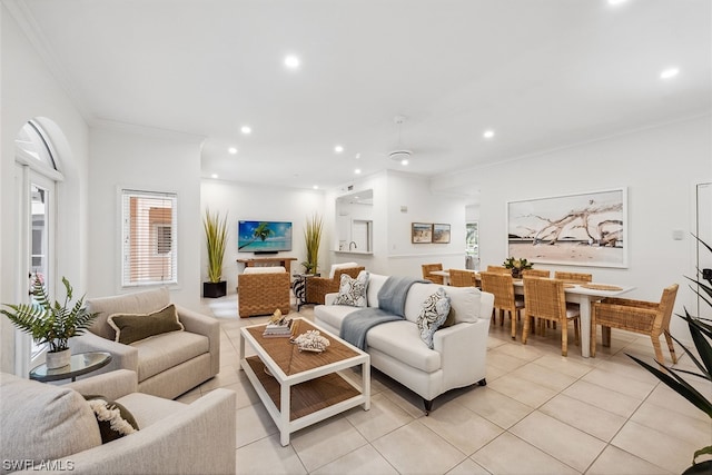 living room featuring ornamental molding and light tile floors