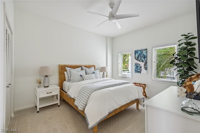 carpeted bedroom with a closet and ceiling fan