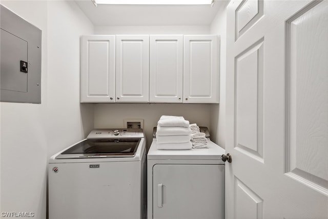 clothes washing area featuring washer hookup, cabinets, and washer and clothes dryer