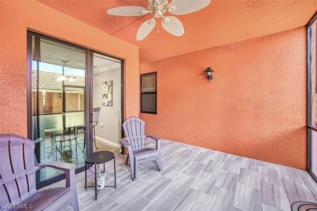 interior space with ceiling fan