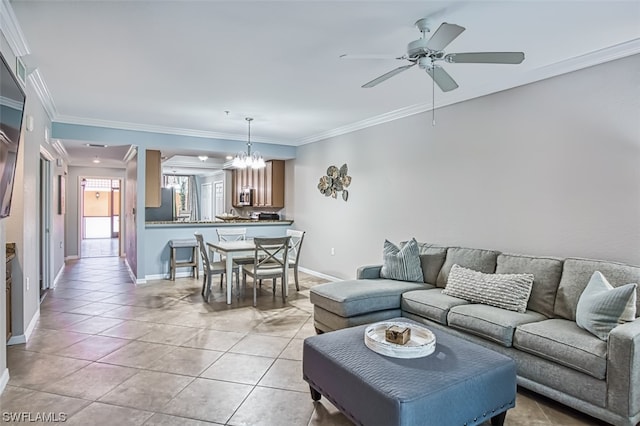 living room with crown molding, ceiling fan with notable chandelier, and light tile floors