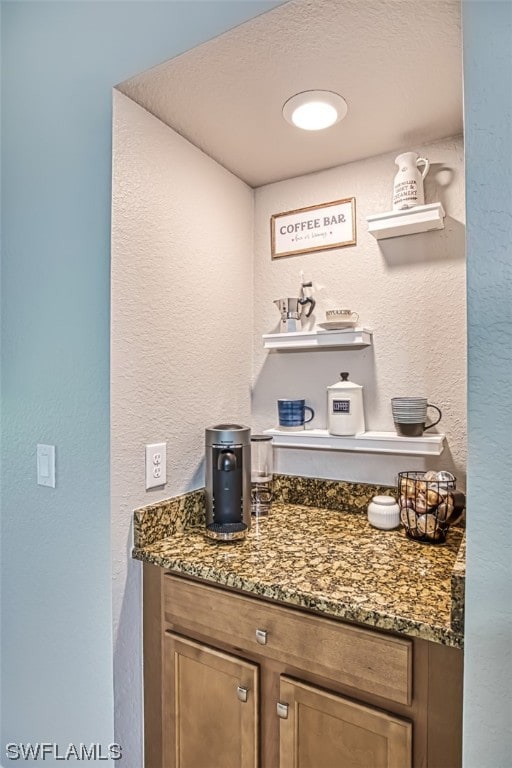 interior space with dark stone countertops