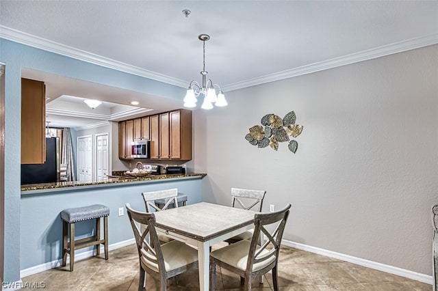 dining room featuring a chandelier, light tile flooring, a raised ceiling, and ornamental molding