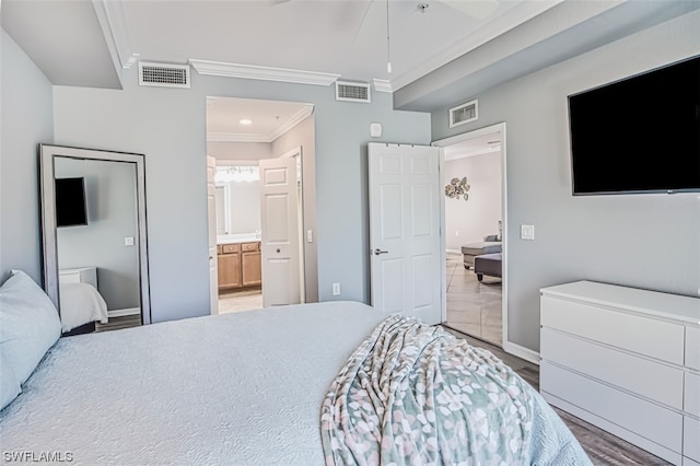 bedroom featuring light tile flooring, ensuite bathroom, ceiling fan, and crown molding