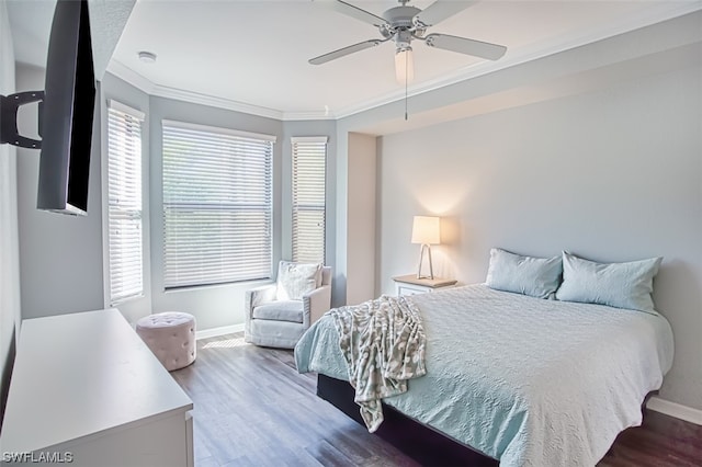 bedroom featuring hardwood / wood-style floors, crown molding, and ceiling fan