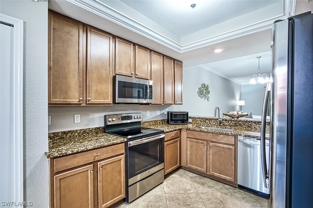 kitchen featuring a chandelier, stainless steel appliances, dark stone countertops, and sink