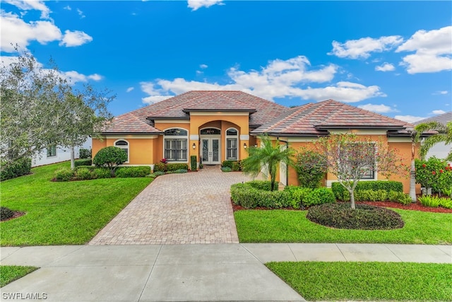 mediterranean / spanish-style house with a front yard