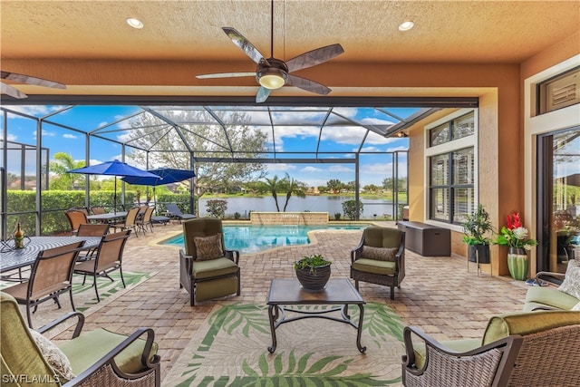 view of patio with glass enclosure and ceiling fan