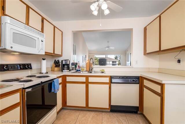 kitchen with light tile flooring, ceiling fan, white appliances, and sink