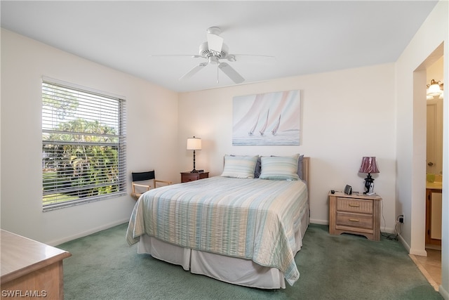 carpeted bedroom featuring ensuite bathroom and ceiling fan