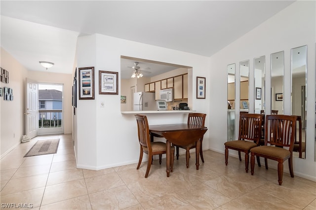 sitting room featuring light tile floors and ceiling fan