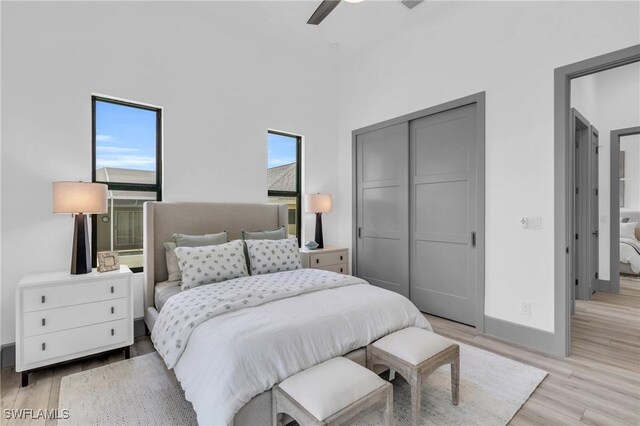 bedroom with light wood-type flooring and ceiling fan