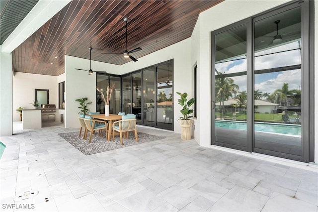 view of patio / terrace featuring exterior kitchen and ceiling fan