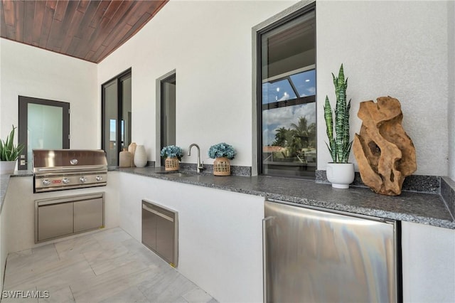 view of patio / terrace with area for grilling, sink, and exterior kitchen