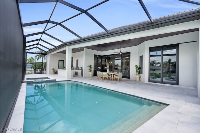 view of swimming pool with ceiling fan, a patio, and glass enclosure