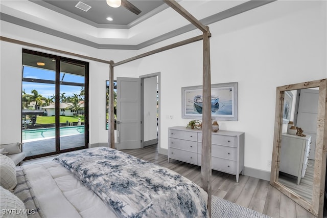 bedroom featuring access to exterior, ceiling fan, and light wood-type flooring